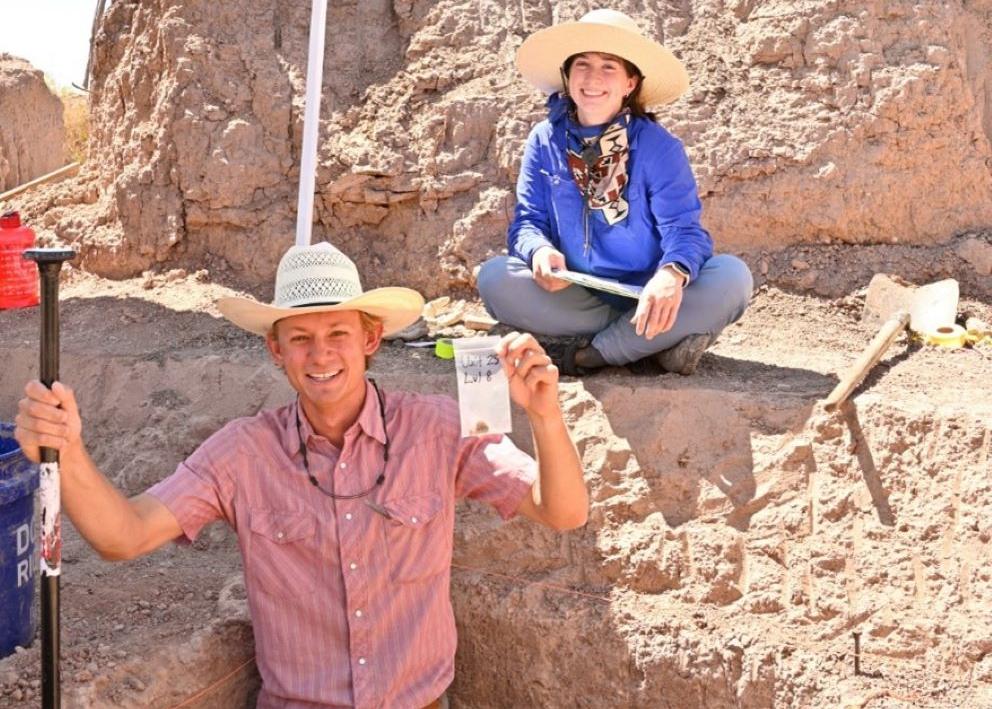 Sam Stone (front) and Natalie Nickels (back) in Unit 25, holding up the first Clovis-aged stone artifacts found within an excavation unit at the GLD site.