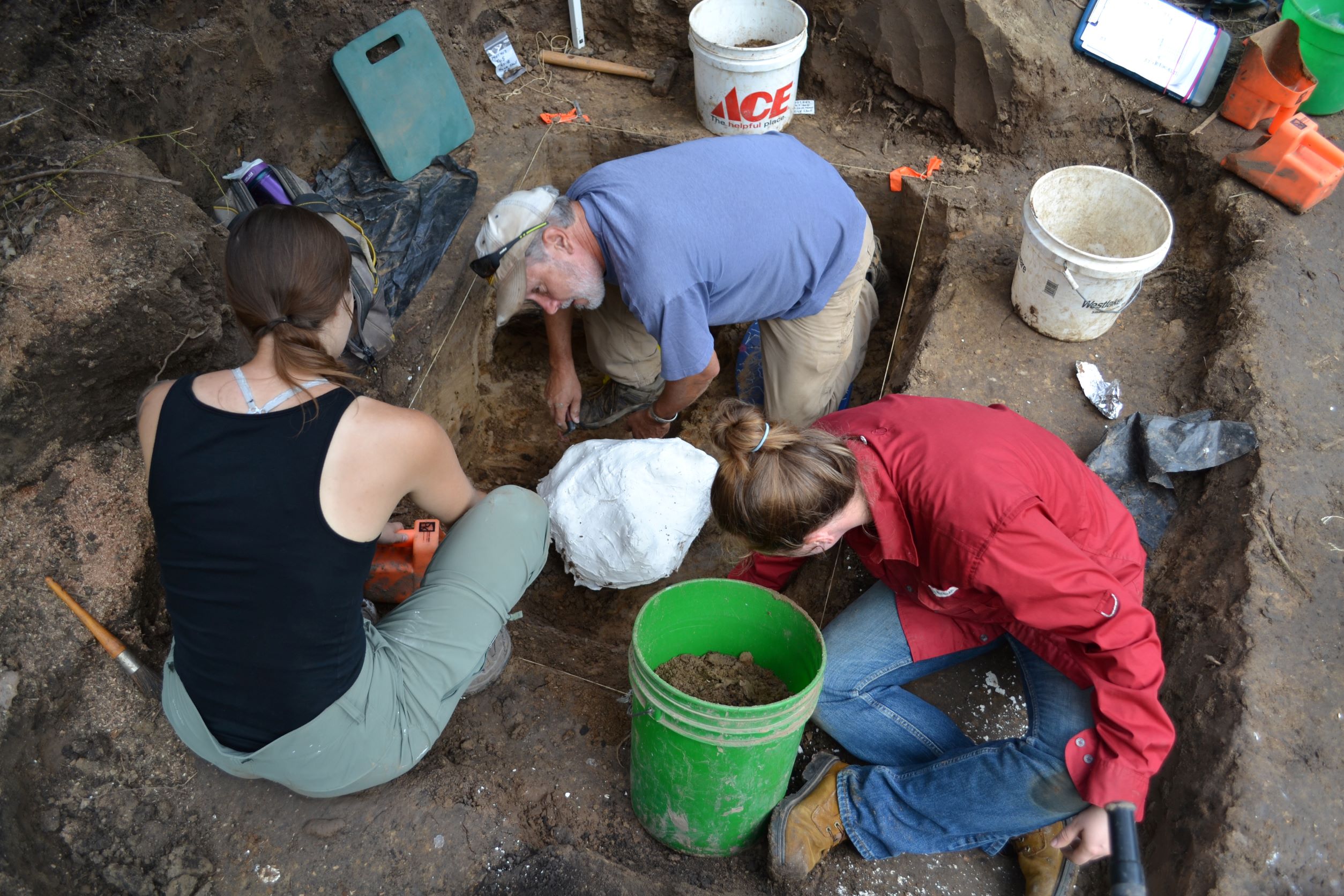 Three individuals excavating a unit at Pipe Creek.