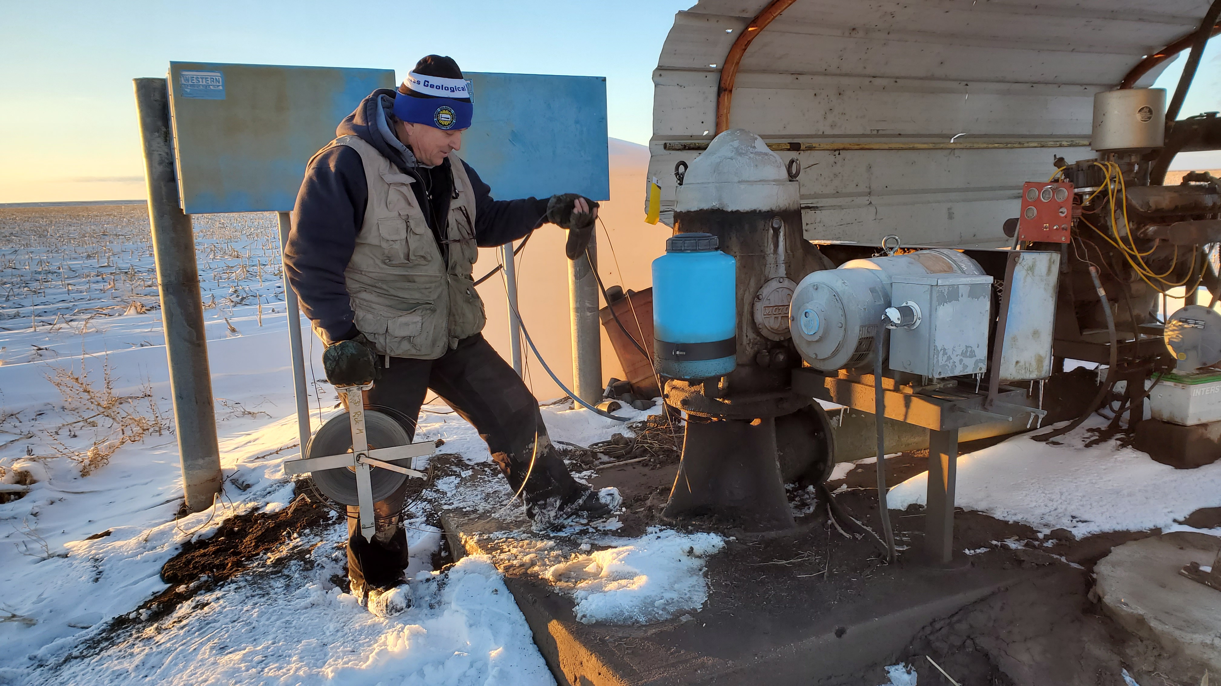 "Rick Miller, Kansas Geological Survey senior scientist, measures water levels as part of a program to monitor the health of aquifers in western and south-central Kansas."