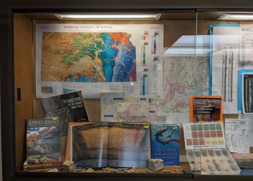 Our store windowcase, showing books, maps, and rock kits for sale.